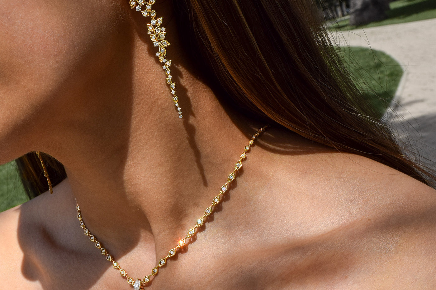 Model wears matching Yellow Gold Necklace and Earrings in Yellow Gold with intricate petal shaped Diamonds