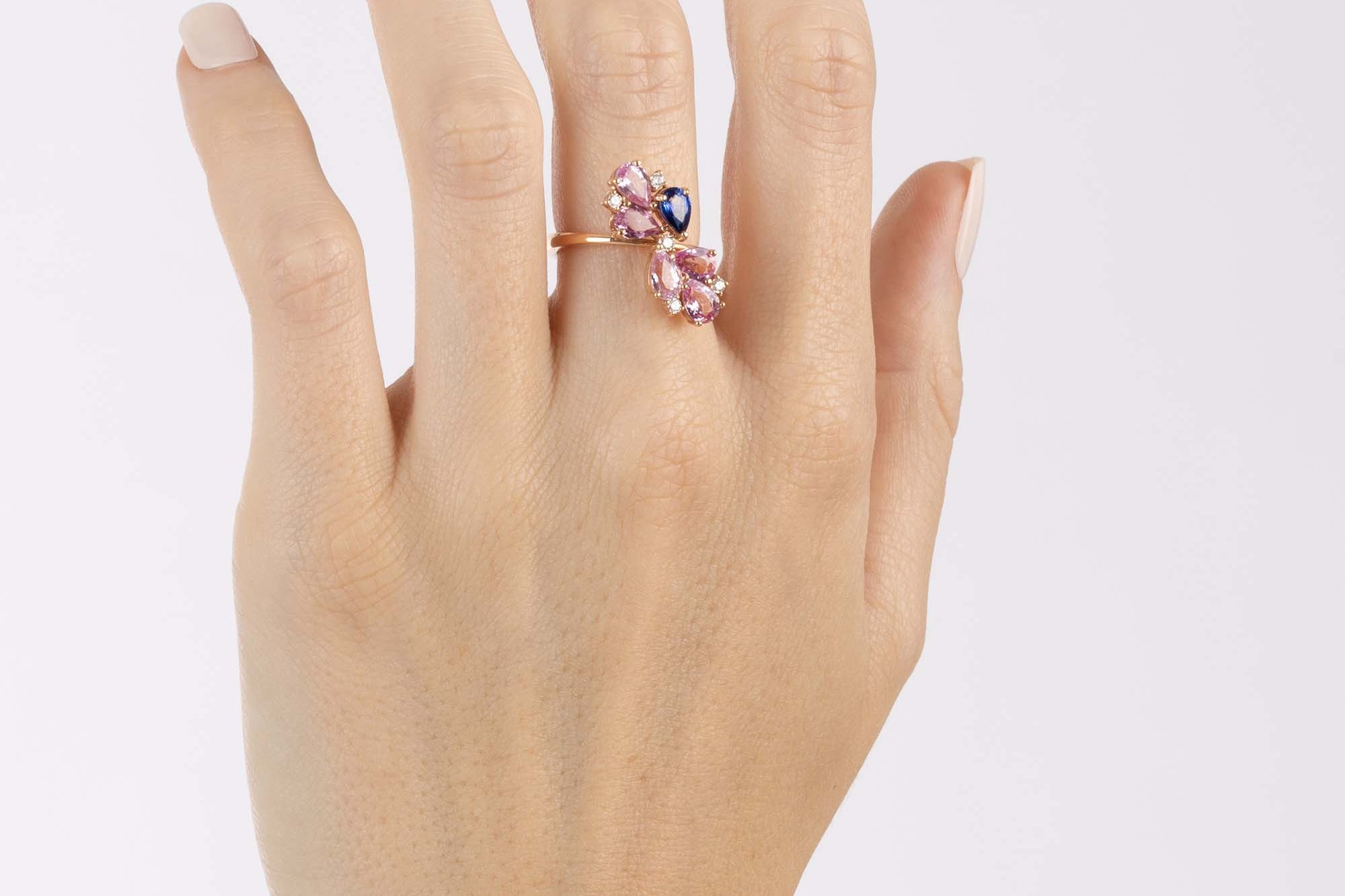 Rose Gold Ring with Pink Sapphires and a Blue Sapphire, and small round Diamonds - Model shot