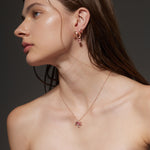 Rose Gold ribbon shaped Earrings with an oval shaped Pink Sapphire, Large - Model shot
