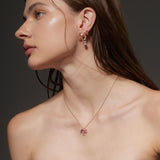 Rose Gold ribbon shaped Earrings with an oval shaped Pink Sapphire, Large - Model shot