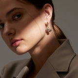 Earrings with Yellow Gold ribbon shape and White Gold macrame knots, Medium - Model shot