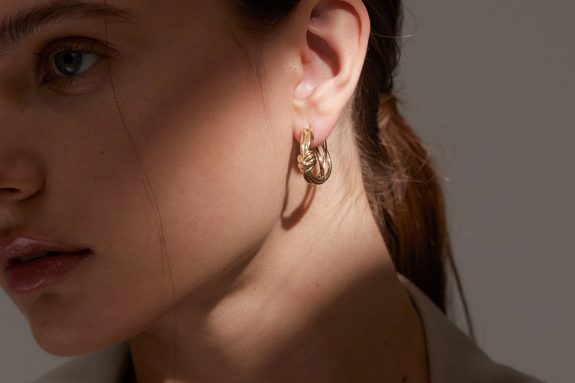 Yellow Gold hoop Earrings with Yellow Gold macrame knot, Medium - Model shot