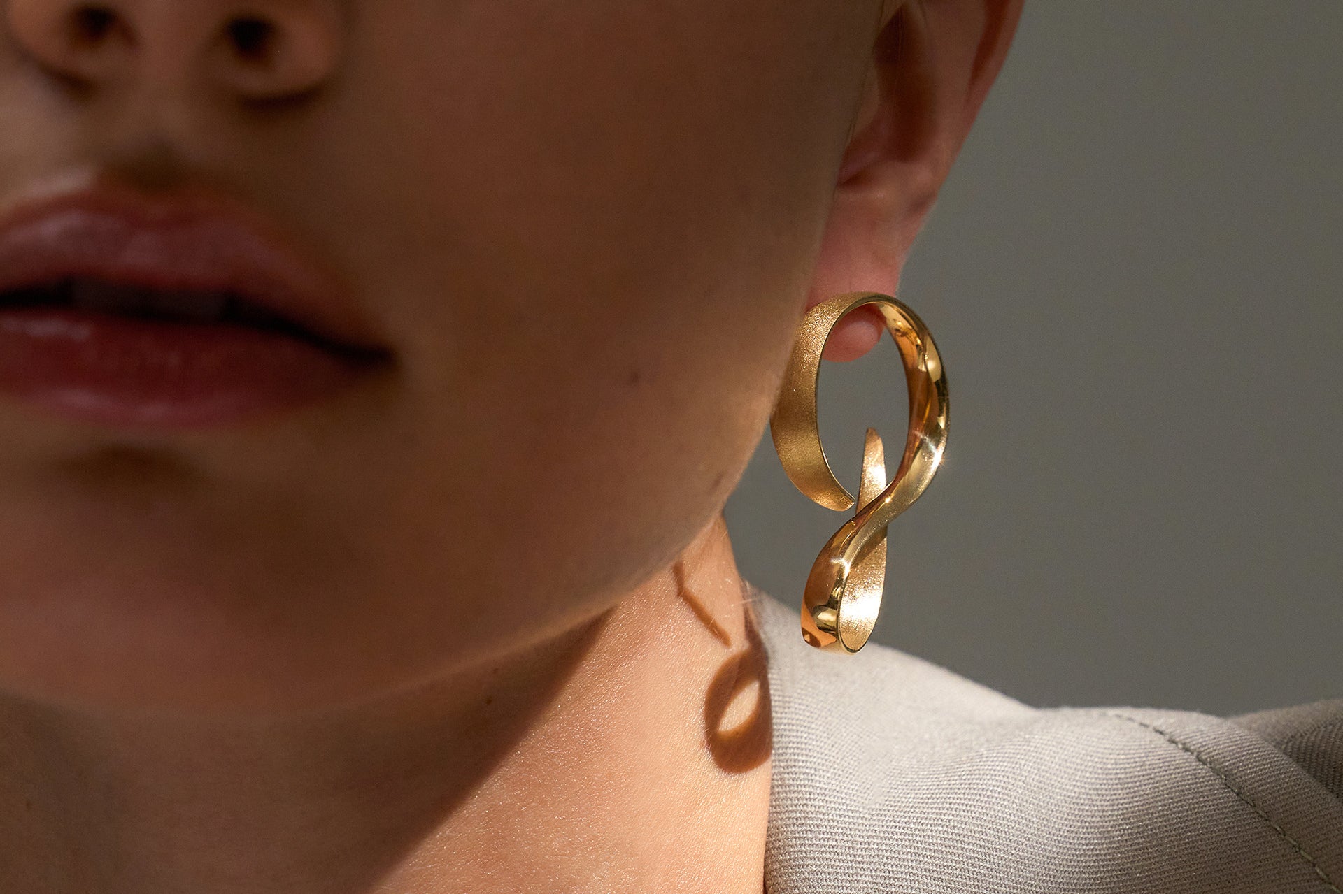 Yellow Gold Earrings in an extended S shape, Large - Model shot