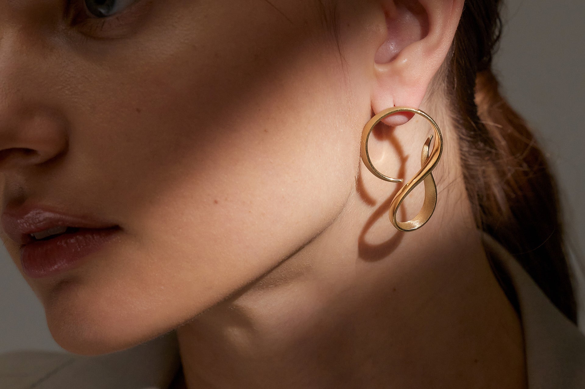 Yellow Gold Earrings in an extended S shape, Large - Model shot