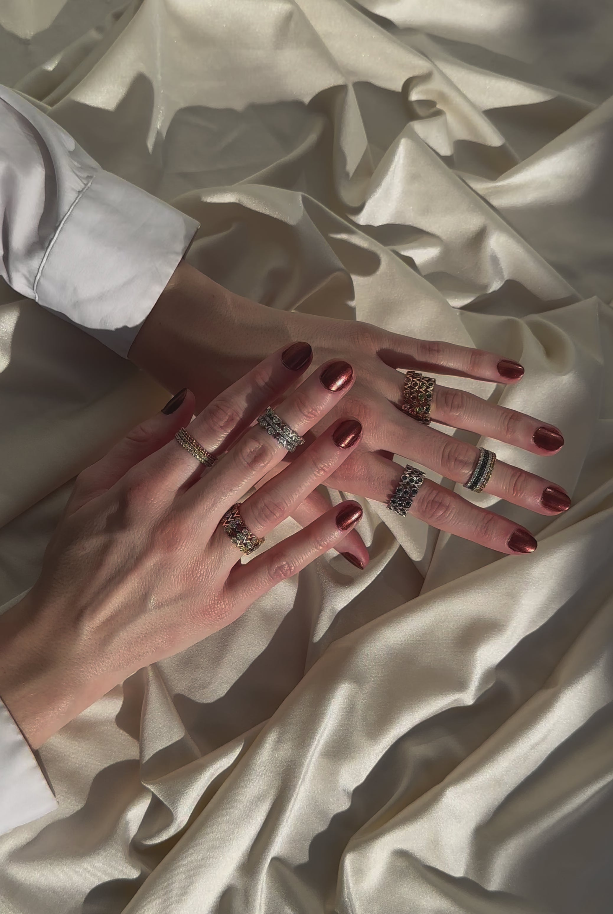 Models wear various stacks of rings as she moves her fingers